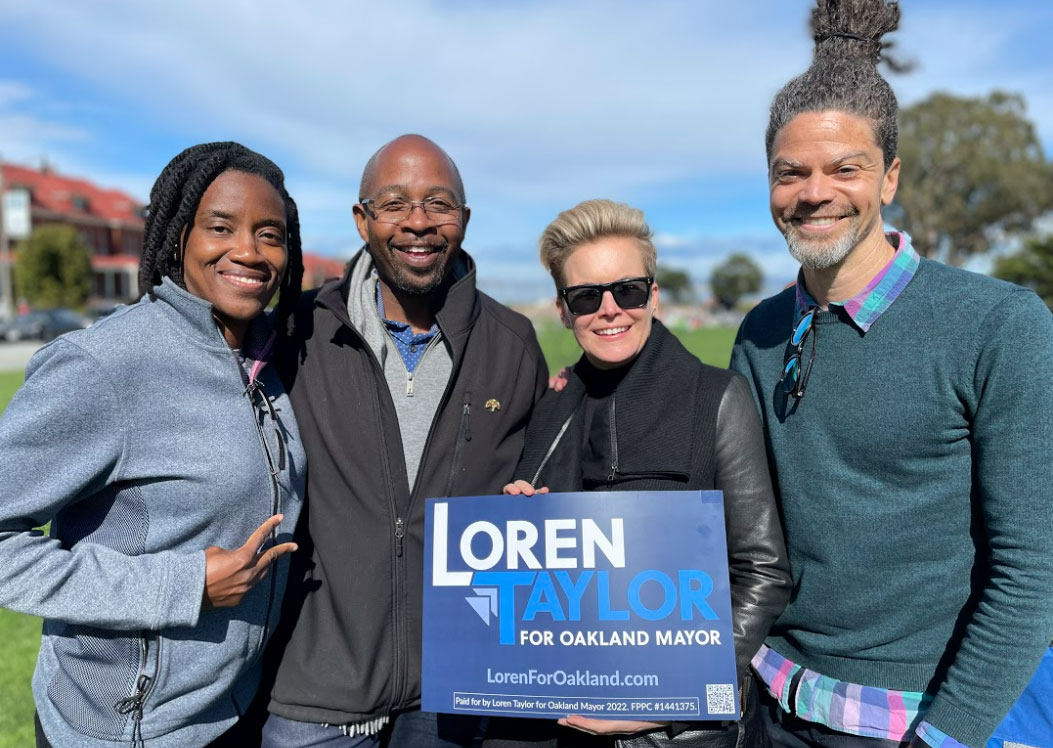 Loren Taylor with group of people in park holding up a "Loren Taylor for Mayor" sign